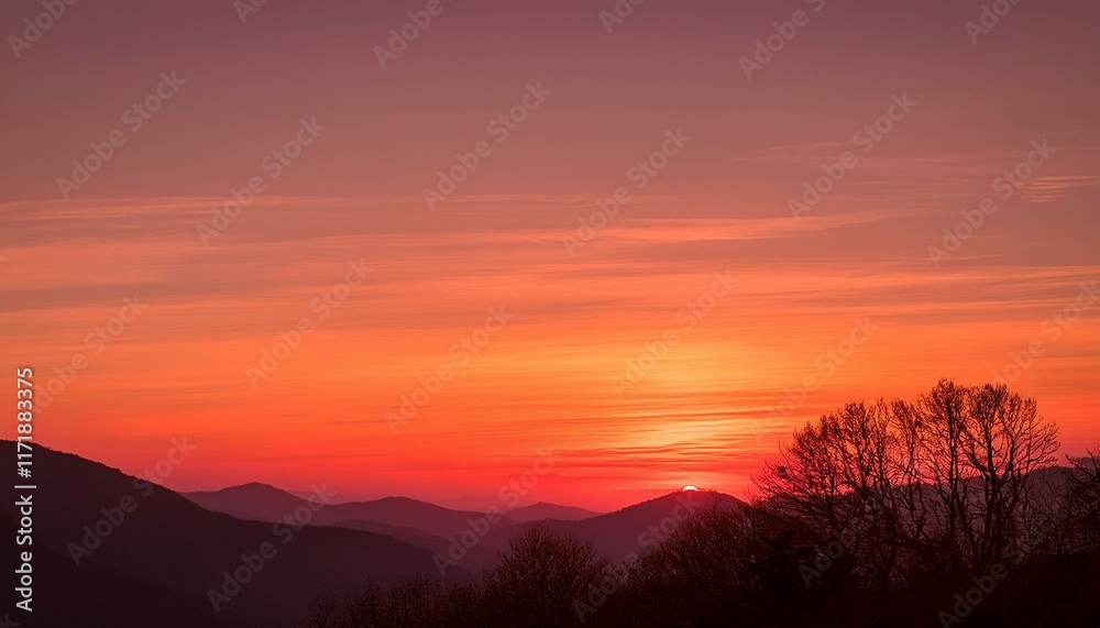 Fiery sunset over a mountain range, painting the sky in shades of orange and pink. Fiery sunset over a mountain range, painting the sky in shades of orange and pink.