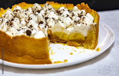 Traditional banoffee cake with banana and caramel sauce filling sprinkled with grated dark chocolate and coffee . English traditional pie photo