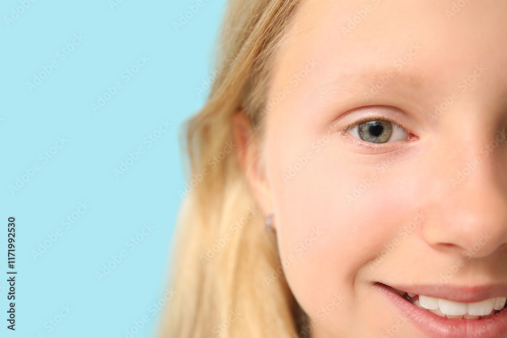 Teenage girl on blue background, closeup. Children's Eye Health and Safety Awareness Month Teenage girl on blue background, closeup. Children's Eye Health and Safety Awareness Month