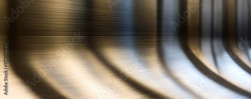 Brushed metal texture reflecting curved lines of light and shadow