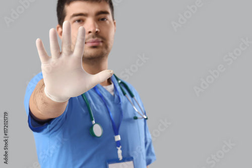 Male doctor showing STOP ge...