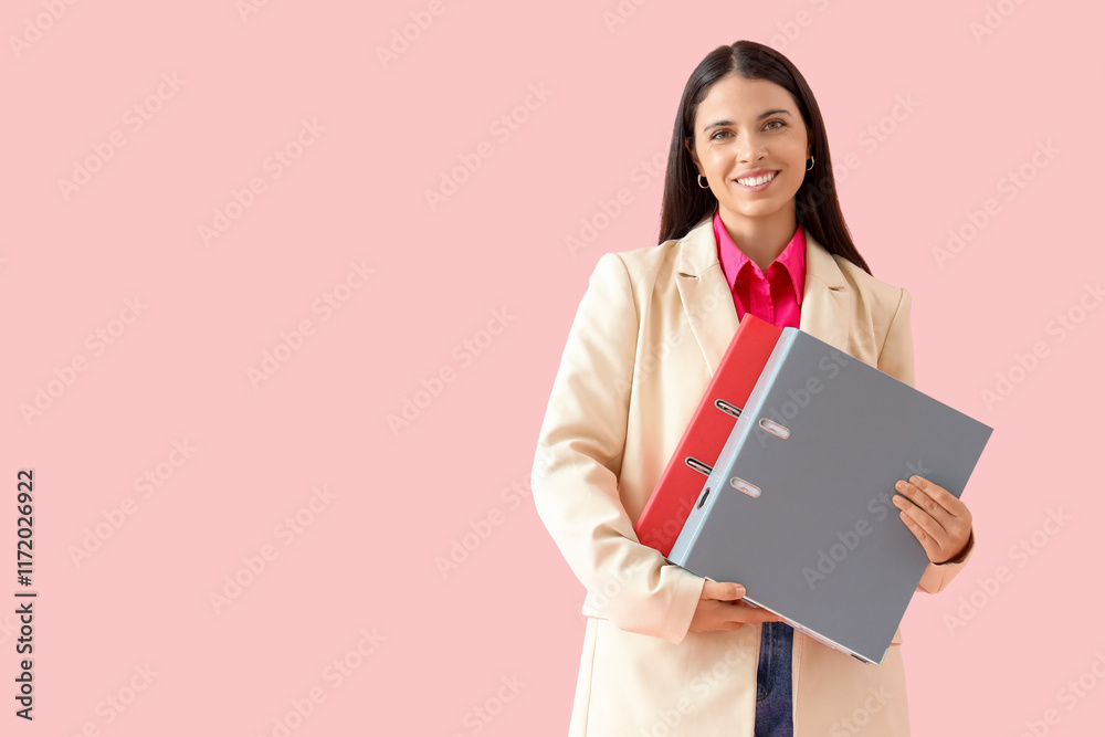 Young businesswoman with folders on pink background Young businesswoman with folders on pink background