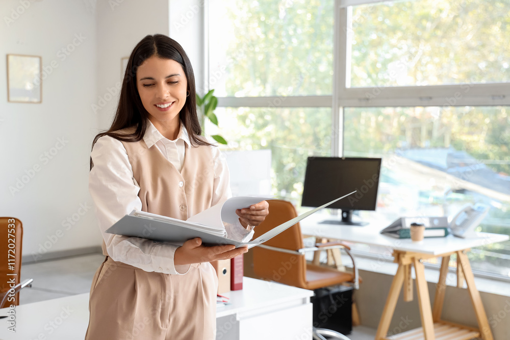 Young businesswoman with folder in office Young businesswoman with folder in office