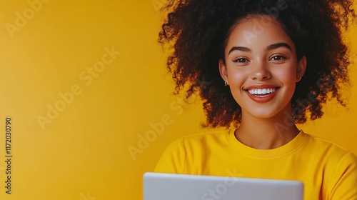 Happy woman using tablet, yellow background.