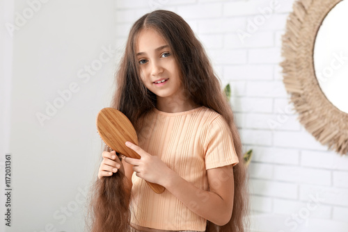 Young girl brushing long br...