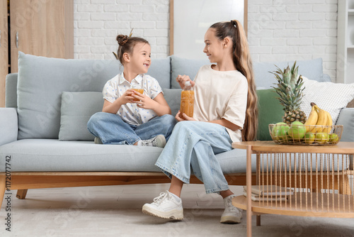 Cute girls with juice sitti...