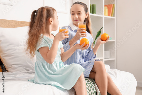 Cute girls with juice sitti...
