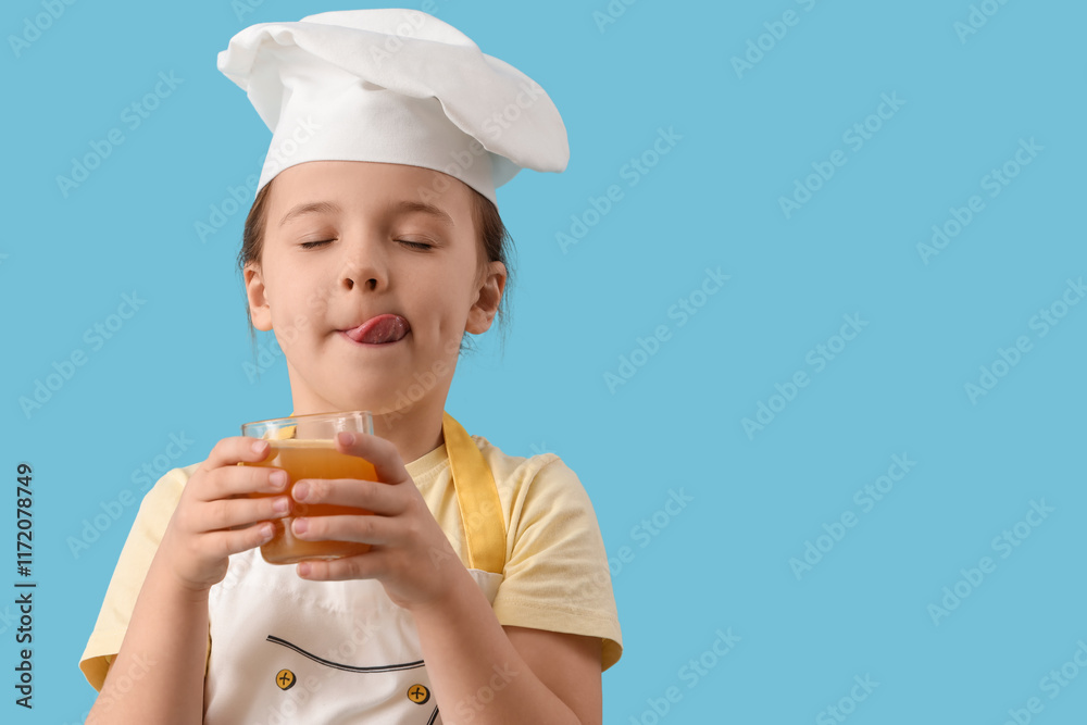 Cute little chef with juice on blue background, closeup Cute little chef with juice on blue background, closeup