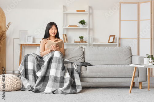 Young Asian woman with warm...