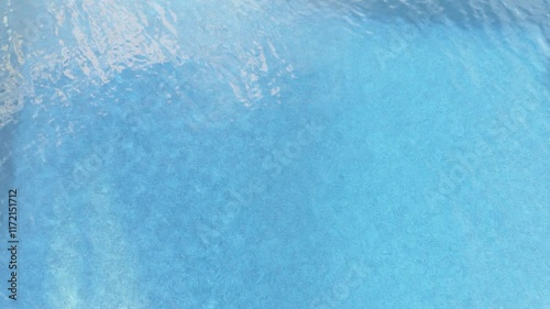 Swimming pool top view close up. Ripples on the water of the pool, transparent, sparkling, inviting surface of the water in motion, view from above. Looped video.