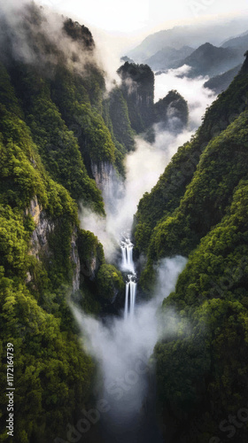 breathtaking aerial view of waterfalls cascading through lush green mountains, surrounded by mist and fog, creating serene and dramatic landscape