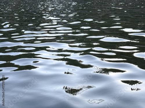 The water is calm and still, with the sun reflecting off the surface