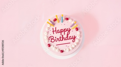 Round birthday cake with pink icing, decorated with red candies, white frosting, and candles is featured. The text reads “Happy Birthday” photo