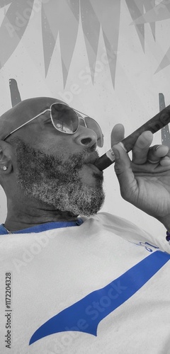 Handsome bald black middle aged man wearing sunglasses smoking a cigar