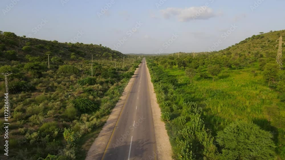Aerial view of highway road through forest fields and green countryside. Aerial view of highway road through forest fields and green countryside.