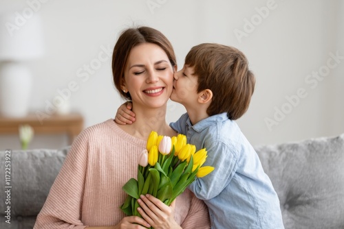 Wallpaper Mural Joyful mother receiving affectionate kiss from son with tulips Torontodigital.ca