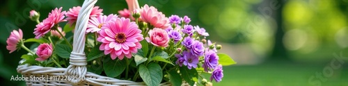 Pink and purple flowers in a white wicker basket filled with greenery, arrangement, garden