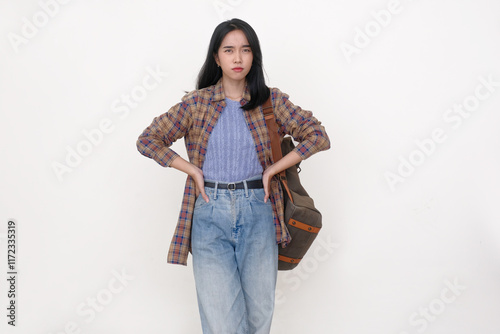 Slika na platnu Indonesian young woman standing with both hands on her hips, facial expression i