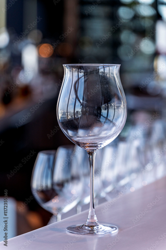Wine and Drink glasses are arranged in front of drinks counter bar with cityscape background