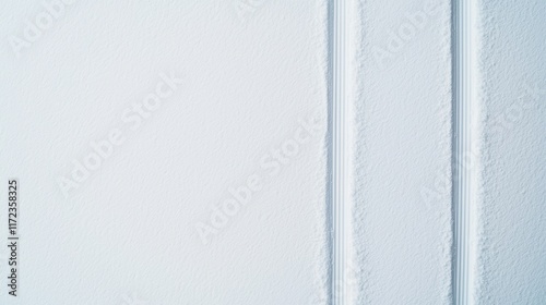 Top view photograph of white snow with vertical tire tracks, for use as a background or texture.
