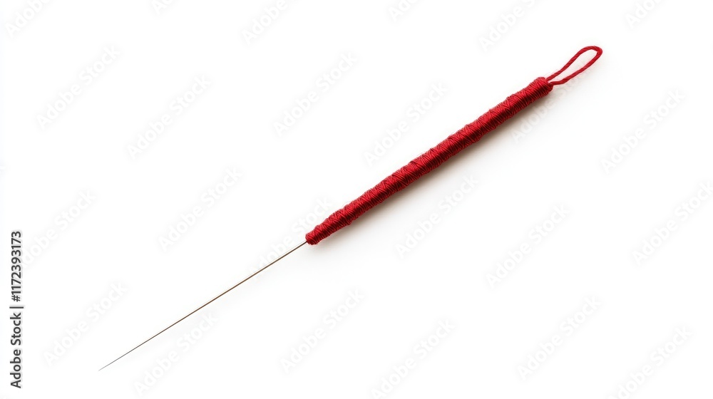 Fototapeta premium Red-handled sewing needle on a white background ideal for illustrating textile crafts and sewing concepts