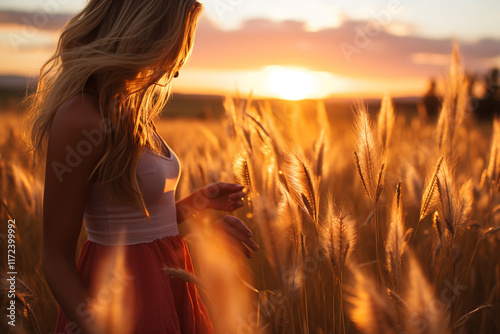 serene and dreamlike atmosphere is created by sun's glow as it sets behind a field of tall grass photo