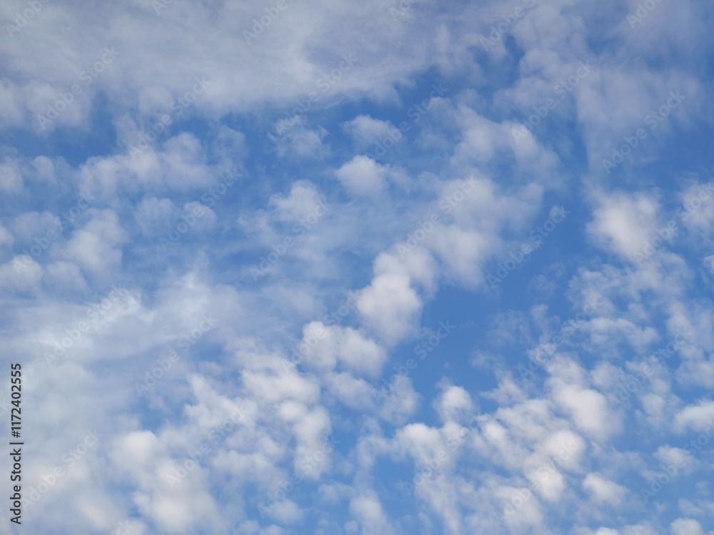 Bright blue sky with scattered white clouds Bright blue sky with scattered white clouds