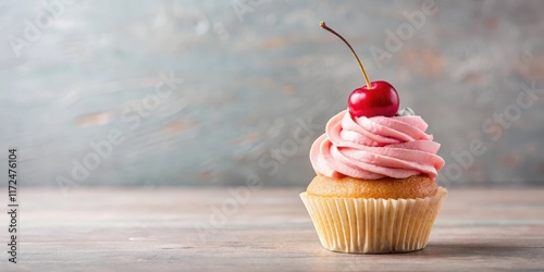 Moist vanilla cupcake topped with a fluffy pink buttercream frosting, adorned with a single red cherry on top