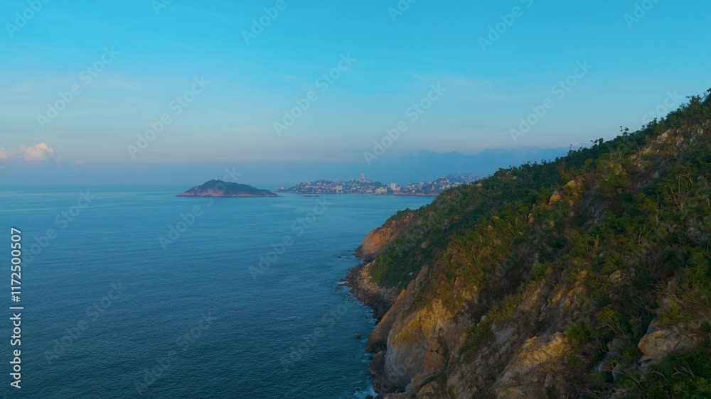Aerial shot skirting the rocky shore of Punta Bruja. The camera rises steeply revealing Acapulco Bay. Aerial shot skirting the rocky shore of Punta Bruja. The camera rises steeply revealing Acapulco Bay.