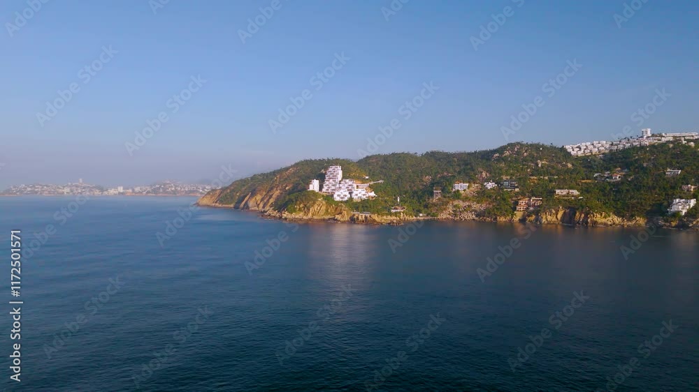 Aerial shot from Punta Bruja in Puerto Marques Bay. The camera rises gently revealing Acapulco Bay in the background. Aerial shot from Punta Bruja in Puerto Marques Bay. The camera rises gently revealing Acapulco Bay in the background.