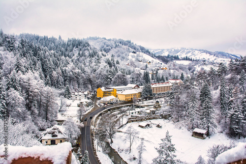 Картината върху платно Snowy winding road traversing sovata resort in harghita county, romania, with sn