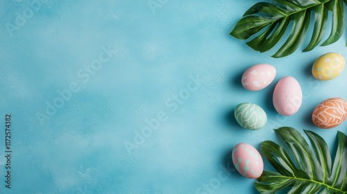 Vibrant Easter Composition with Pastel Eggs and Monstera Leaves on Blue Background photo