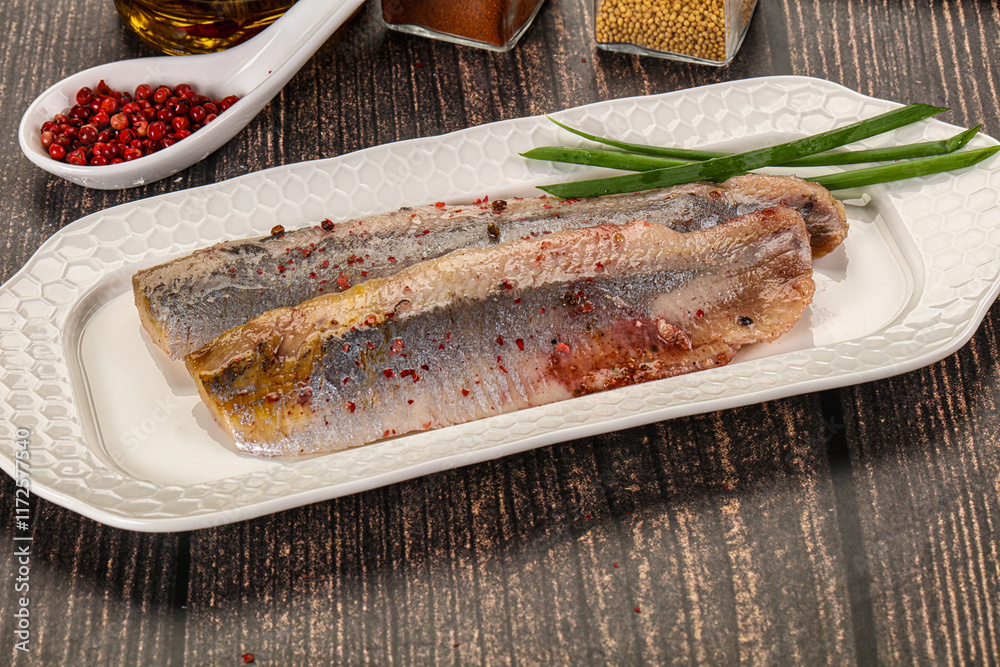 Salted marinated herring fillet with spices Salted marinated herring fillet with spices