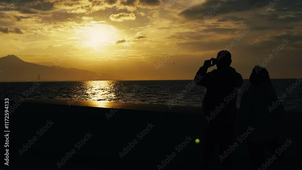 People Silhouette Near the Sea and Sunset Light in Nature People Silhouette Near the Sea and Sunset Light in Nature