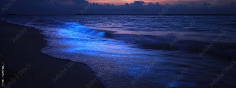 Naklejka premium An enchanting shot of the bioluminescent algae illuminating the waves on a remote beach in the Maldives at night, Bioluminescent waves scene, Luminous style