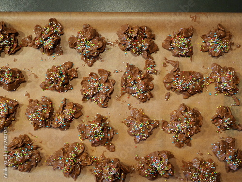 Chocolate crossies, homemade from cornflakes and chocolate, garnished with colorful sprinkles. Perfect for Christmas and parties, creative and delicious photo