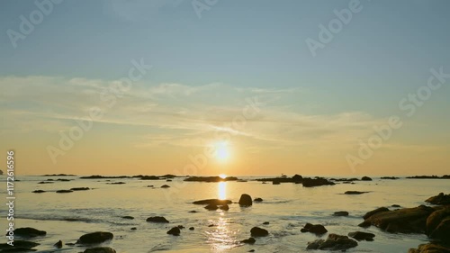 Timelapse stunning scenery of the coastal during sunset. Fast motion footage of the west coast during low tide with dramatic sky. Nangthong Beach. Phang Nga Province. Thailand. photo