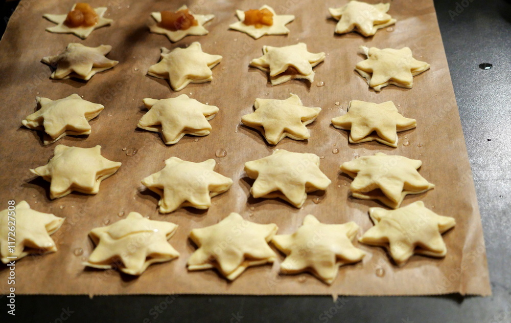 Puff pastry stars with apple filling on reused parchment. A light festive treat, perfect for Christmas or winter-themed designs and inspirations. Puff pastry stars with apple filling on reused parchment. A light festive treat, perfect for Christmas or winter-themed designs and inspirations.