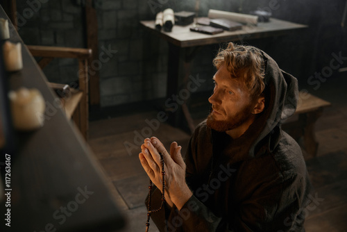 Fotografie Desperate priest kneeling before church altar in mystical smoke