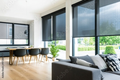 Modern living room with blackout roller blinds, large windows, sofa, and dining table.