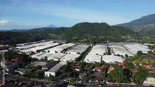 A picturesque view of the industrial zone, with rolling hills and a clear blue sky as its backdrop
