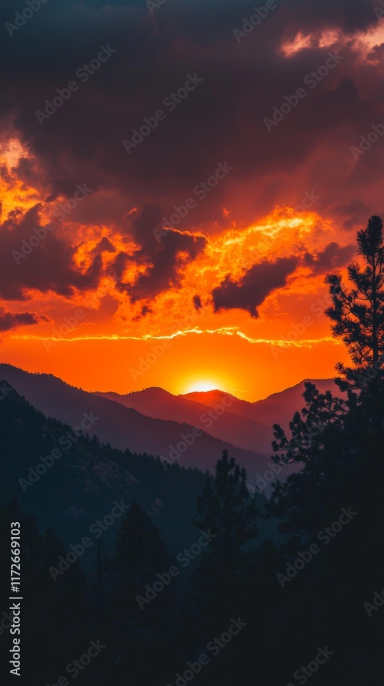 Fototapeta premium Fiery Sunset Behind Mountain Range