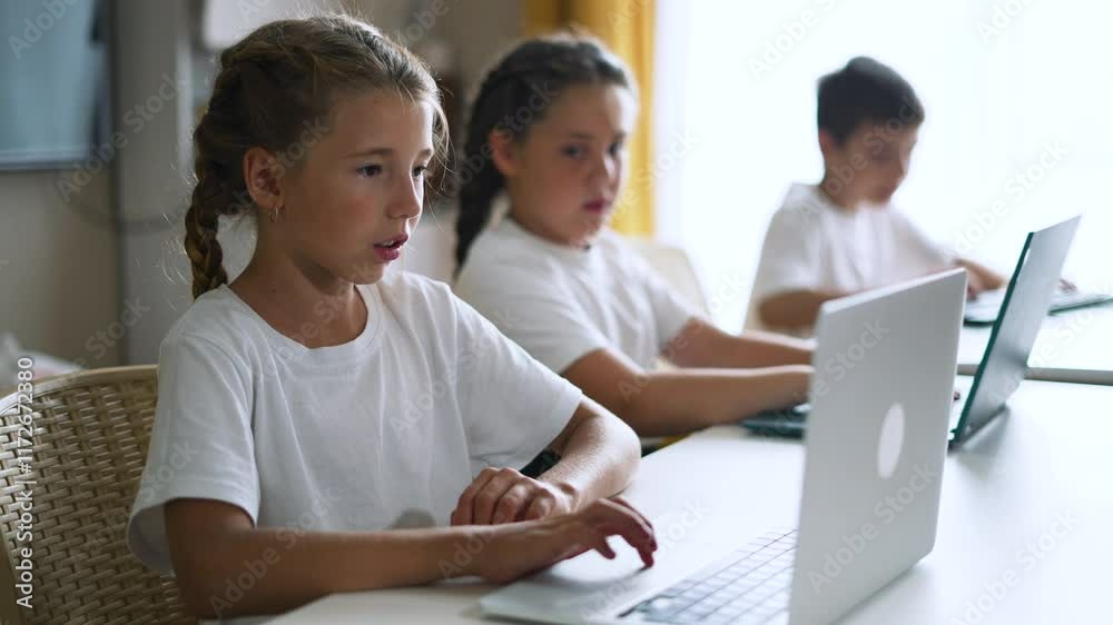 Group of children at school online learning. Teamwork of children with laptop online learning as a team. Children learn together at school to work as team with laptop.Team learning at school in lesson Group of children at school online learning. Teamwork of children with laptop online learning as a team. Children learn together at school to work as team with laptop.Team learning at school in lesson
