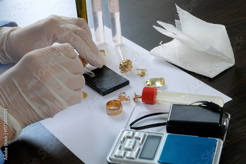 Wallpaper Mural A pawn shop employee tests old gold jewelry using reagents and a touchstone, Buying old gold, closeup Torontodigital.ca
