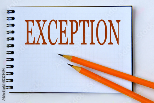 EXCEPTION - word in notebook on white background with pencils