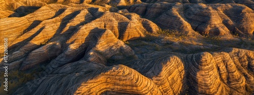 An epic aerial perspective of the Bungle Bungle Range in Purnululu National Park, Australia, showcasing its striped sandstone domes at sunrise photo