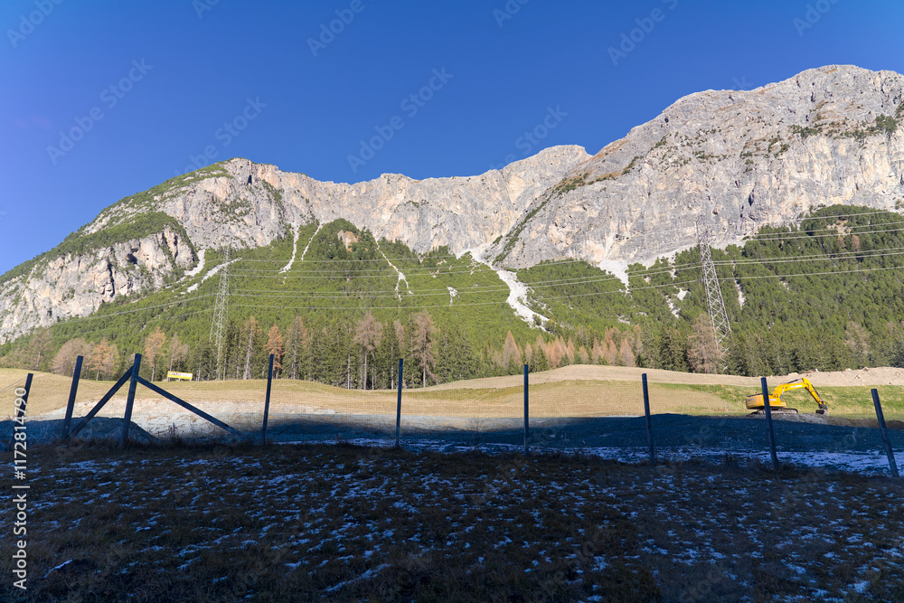 Scenic landscape at Swiss mountain pass Albula with snow and power line on a sunny autumn day. Photo taken November 15th, 2024, Albula mountain pass, Switzerland. Scenic landscape at Swiss mountain pass Albula with snow and power line on a sunny autumn day. Photo taken November 15th, 2024, Albula mountain pass, Switzerland.