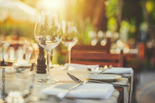 A close up shot of a restaurant table set up with tableware and wine glass. Concept of dining, hospitality and catering. Horizontal image with free space for text. MZ