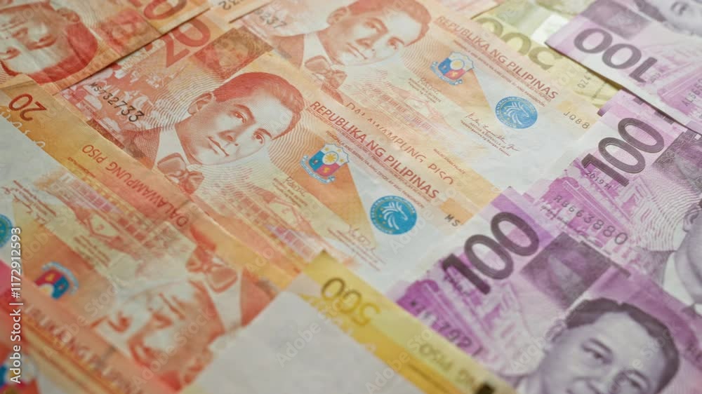 Philippine pesos banknotes scattered in a close-up view, showcasing various denominations such as 20, 100, and 500, highlighting financial themes. Philippine pesos banknotes scattered in a close-up view, showcasing various denominations such as 20, 100, and 500, highlighting financial themes.