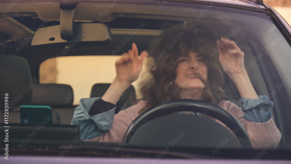 Furious mature woman pulling her hair while driving car